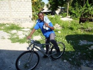 A picture of the young boy sitting on the bicycle