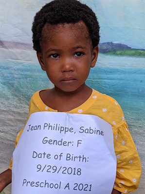 A picture of Sabine Jean Philippe holding the paper