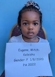 A little girl holding up a sign that says gender f.