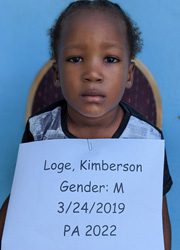 A young girl holding a sign that says loge kimberson.