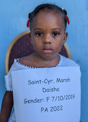 A young girl holding a sign that says saint cyril and dasha.