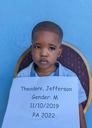 A young boy holding a sign that says theodore jefferson gender m pa 2020.